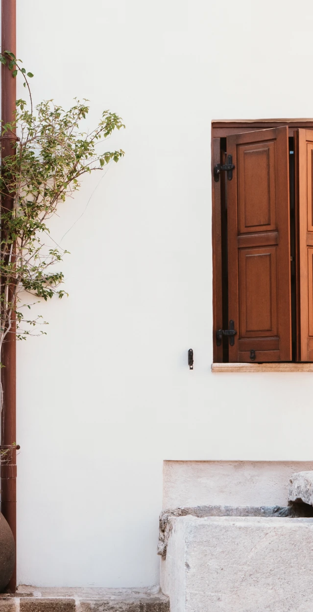Open window with brown shutters