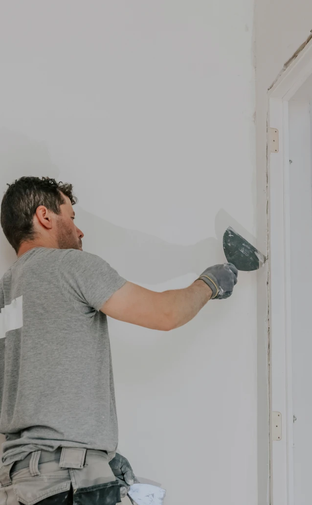 Person smoothing wall with a trowel